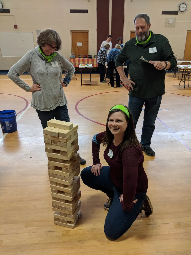 Three people playing Jenga