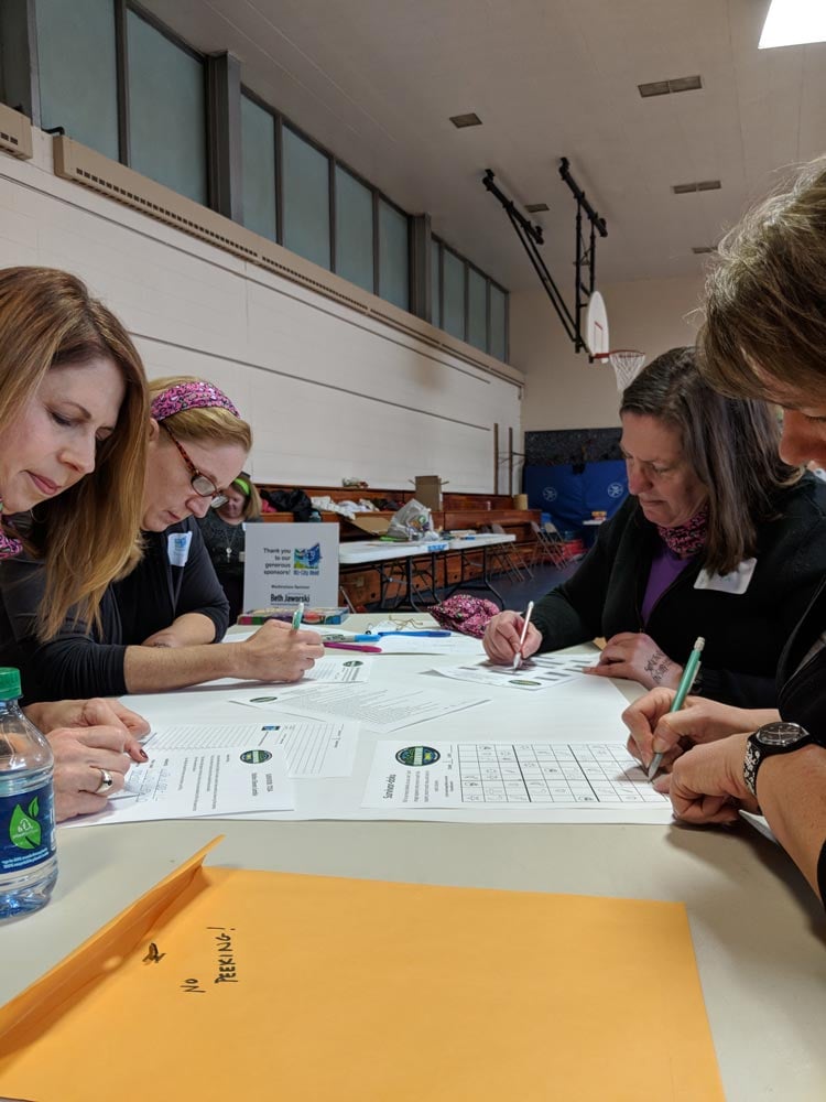 4 women filling out forms at a table